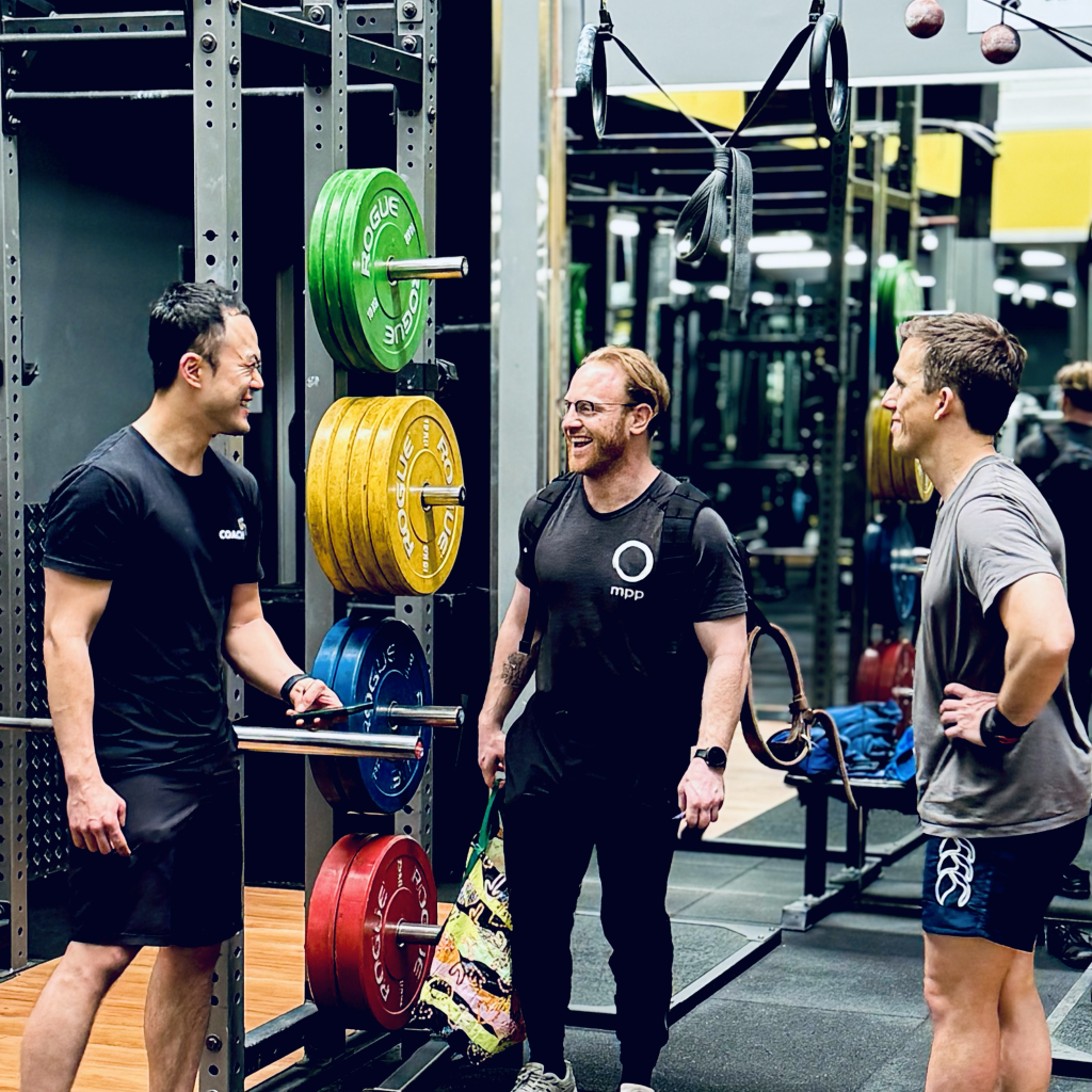three men laughing and connecting at Kindred Training